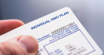 If You’ve Met Your Deductible, Consider Joint Replacement Now man holding HMO plan card