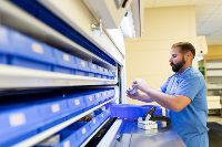 Pharmacy Technician examines medicine