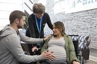 Couple getting ready for labor at hospital with Nurse