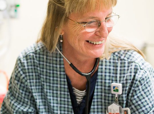 A nurse helps a patient