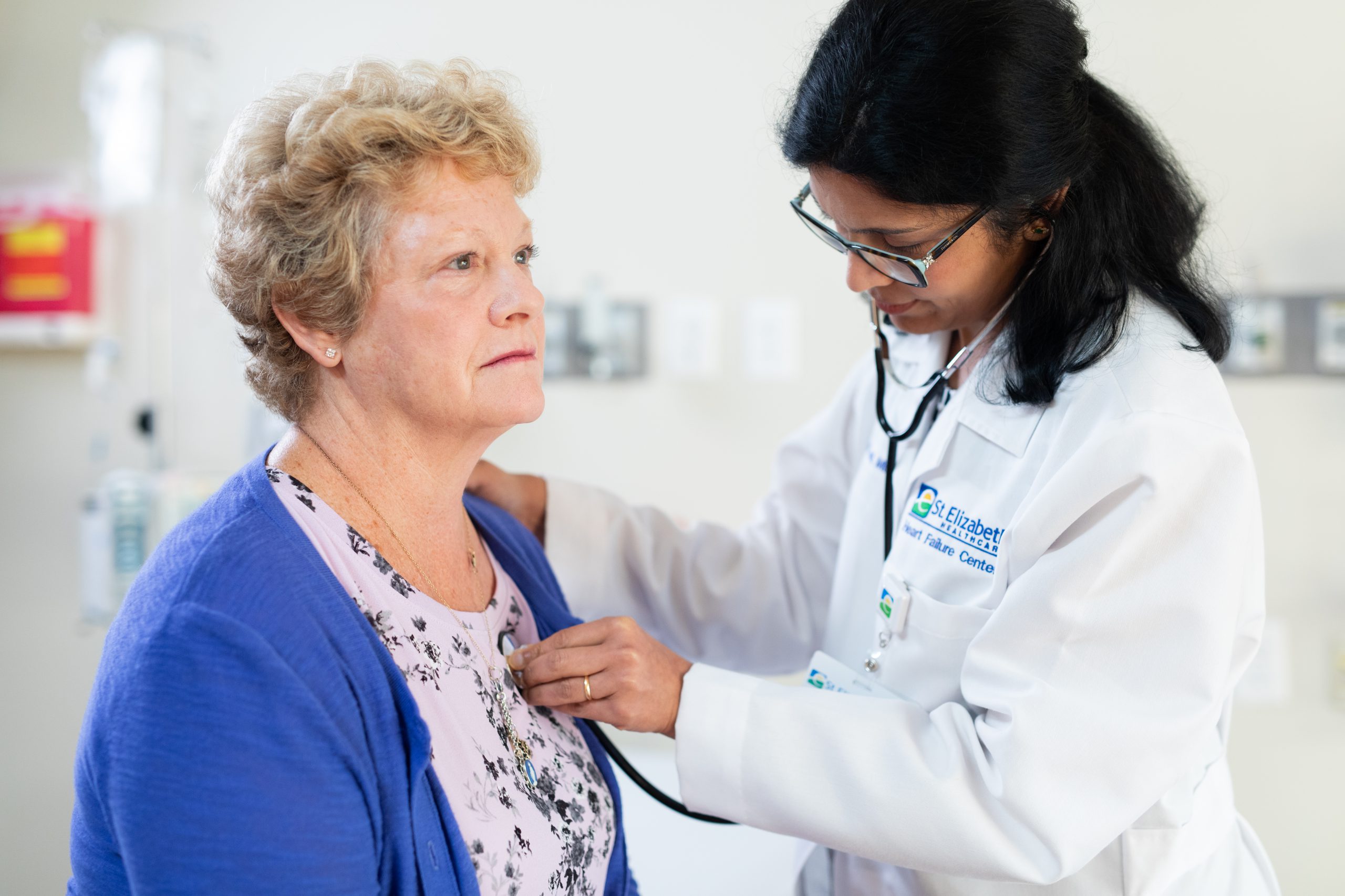 Doctor checks the heart of a patient with a stethoscope