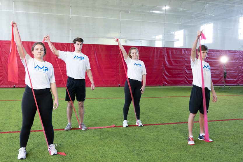 Athletes use exercise bands to stretch