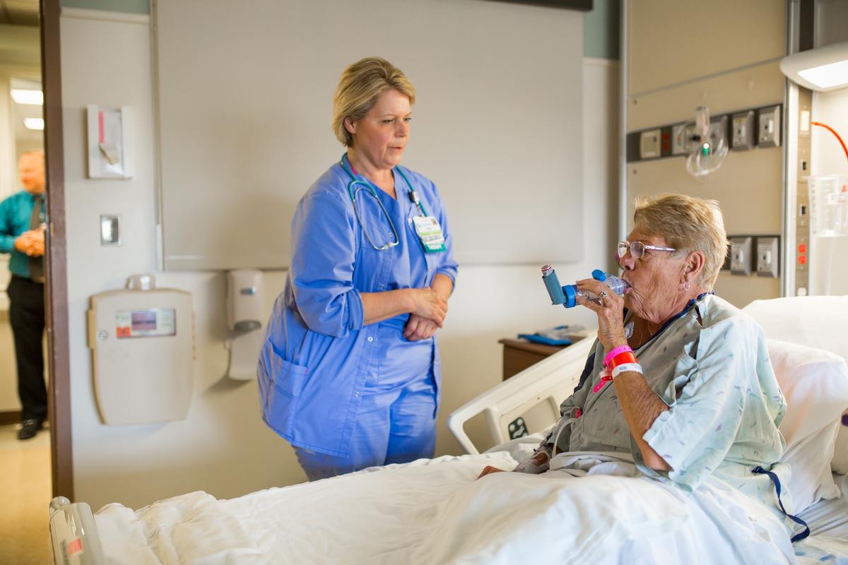 Therapist helps a patient with a breathing treatment
