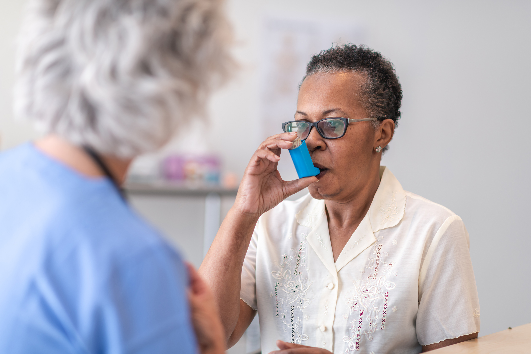 A patient uses an asthma inhaler.