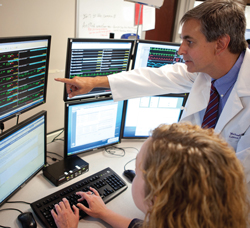 Doctor views monitors for Advanced ICU Care