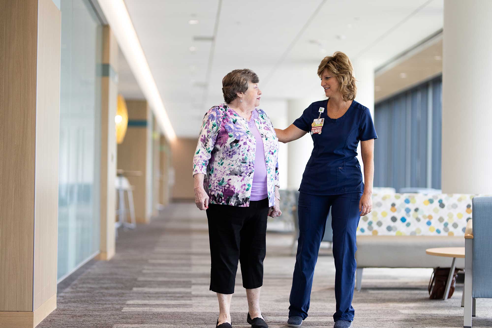 A Nurse Walks with a Patient