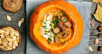 Pumpkin with soup inside, serving as a bowl.