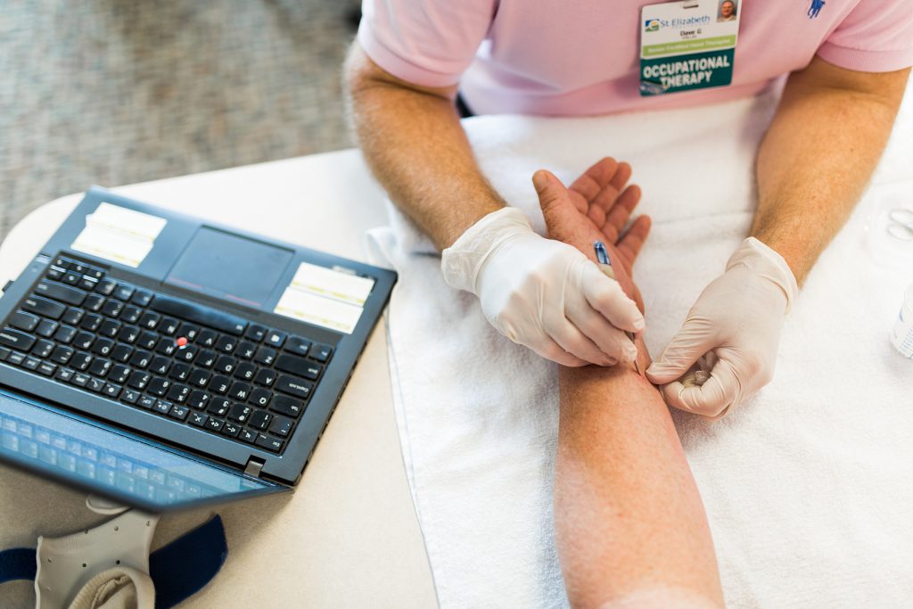 Doctor examining wrist of patient with carpal tunnel syndrome