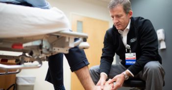 Dr. Gates observing an injured ankle.