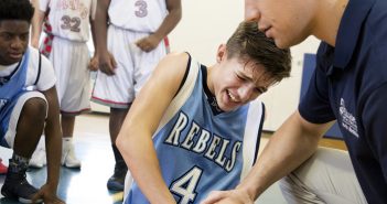 doctor examining basketball player