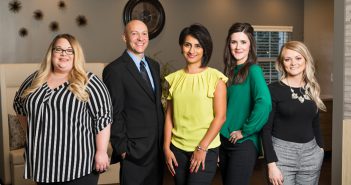 Five doctors who are part of the new St. Elizabeth Concierge Medicine team are standing in an office.