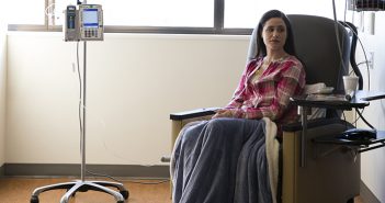 Cancer patient (female) sitting in a chair during a chemo treatment.
