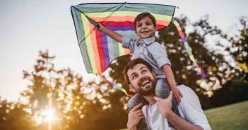 The Truth About Robotic-Assisted Spinal Surgery Handsome dad with his little cute sun are having fun with kite on green grassy lawn