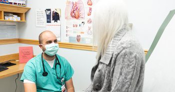 Dr. Schutzman talking with a woman patient.