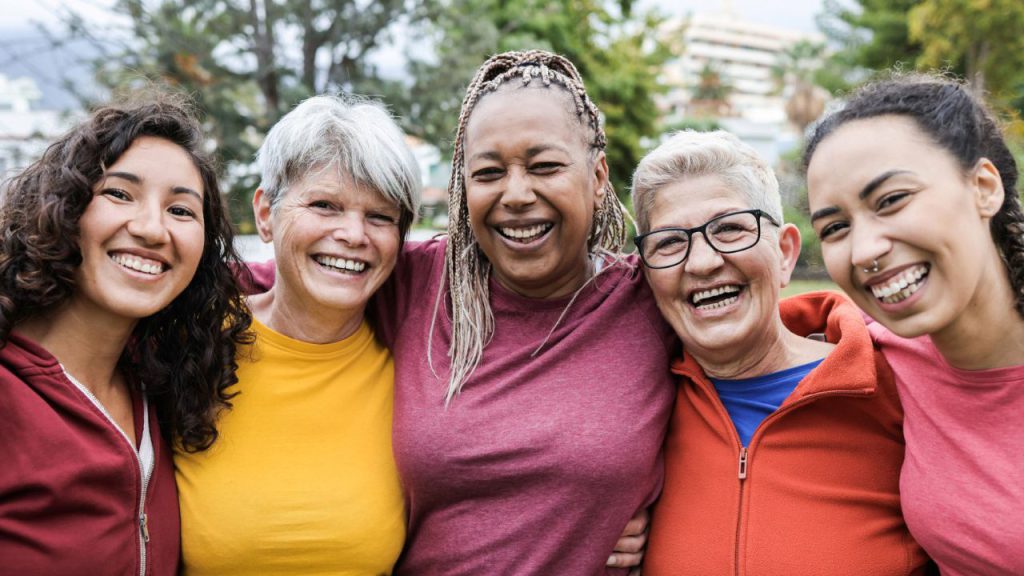 Happy multi generational women having fun together - Multiracial friends smiling on camera after sport workout outdoor.