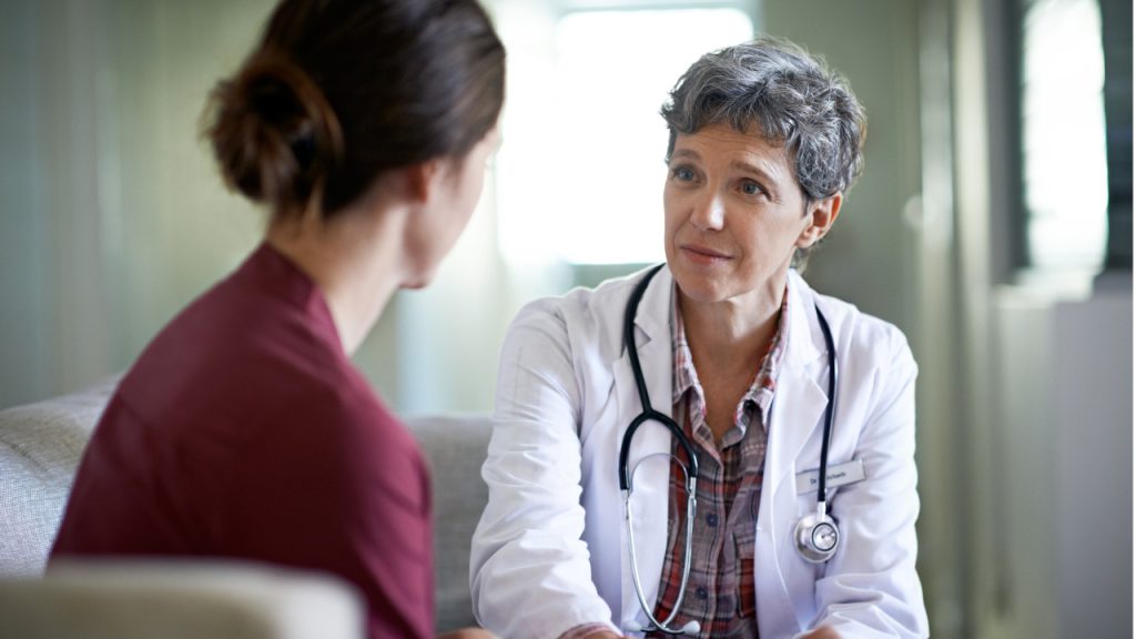 Doctor speaks with female patient