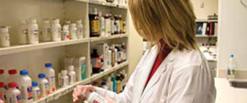 Pharmacist looking at pill bottles