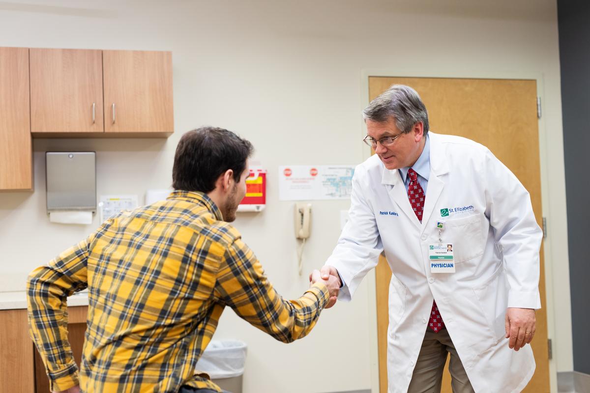 Physician Storytelling Dr. Patrick Kunkler shakes the hand of a patient.