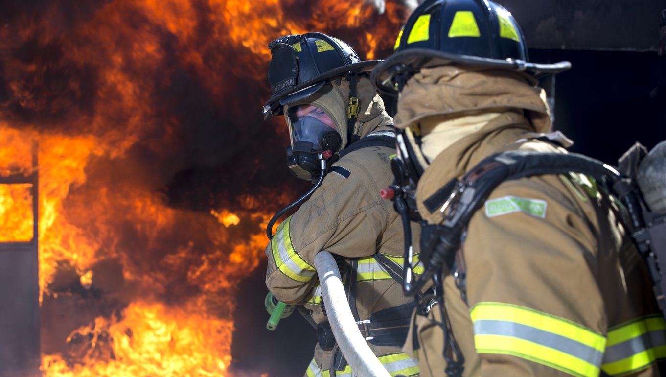 Firefighter ready to spray water Firefighter Cancer Screening Program