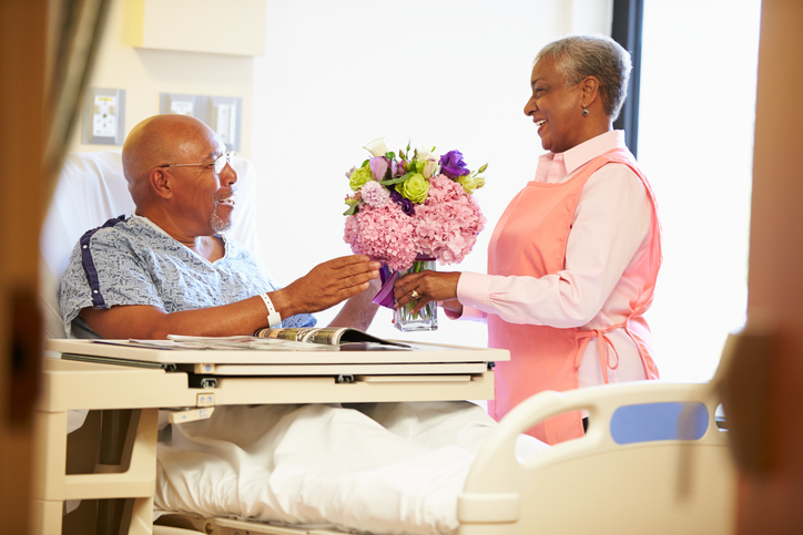 Volunteer Worker Tidying Male Patient’s Hospital Room covington volunteers