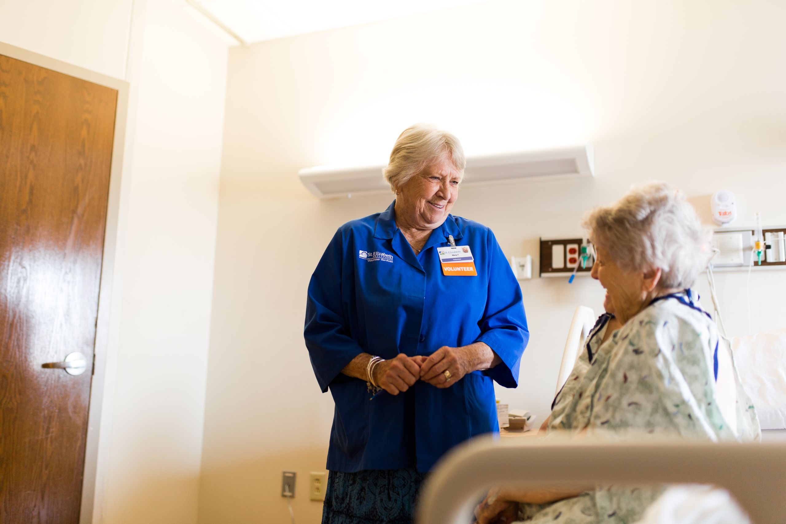 2016 Rudy Volunteer talking to patient patient handbook